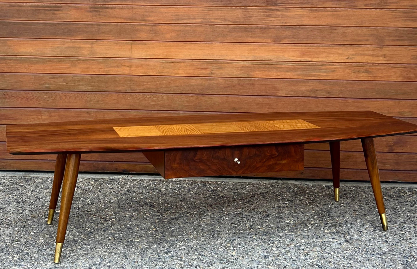 GORGEOUS EXOTIC WOOD SURFBOARD COFFEE TABLE w/ SPLAYED BRASS CAP TAPERED PEG LEGS/ CENTRAL CONTRAST EXOTIC WOOD INLAY & STORAGE DRAWER