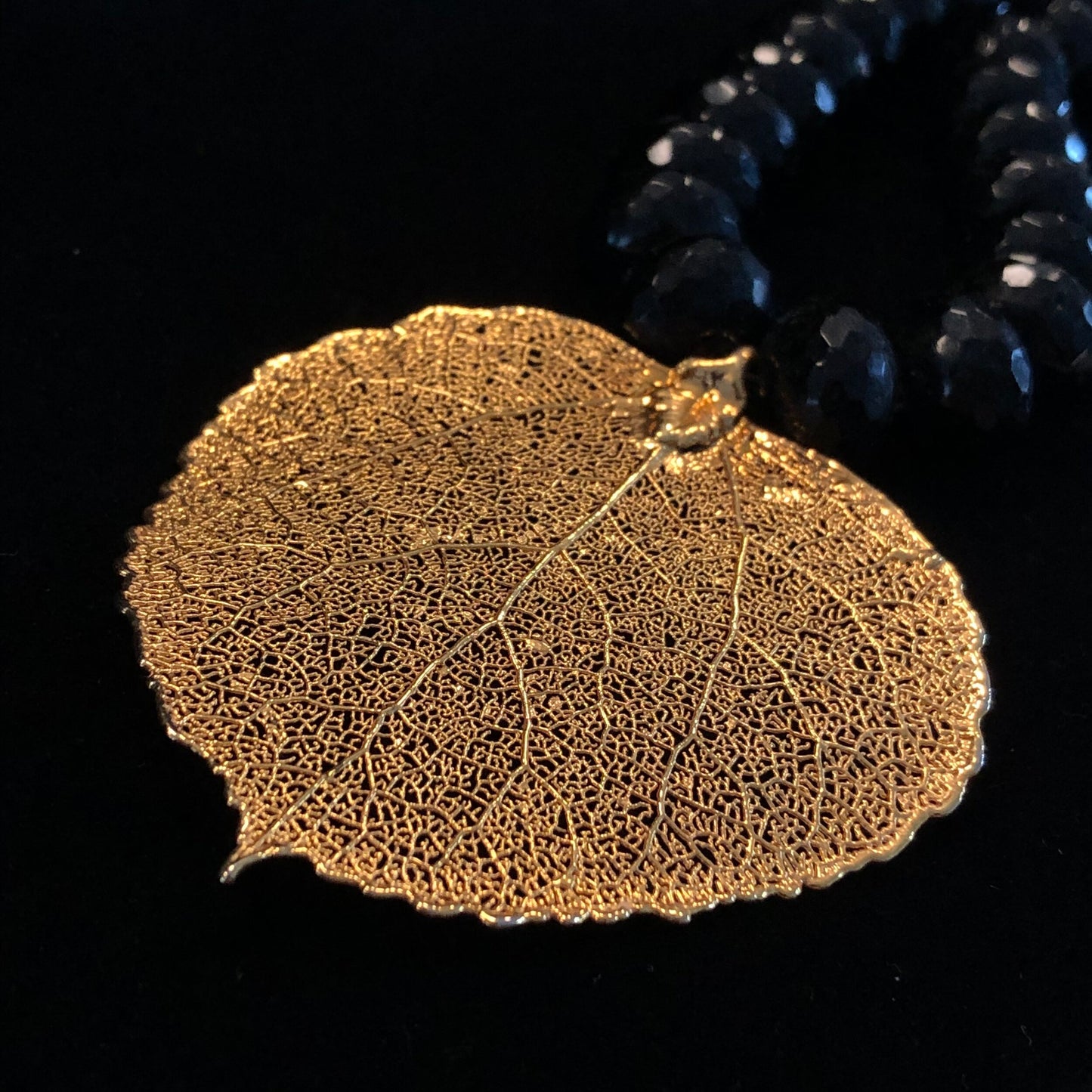 HEAVY BLACK FACETED BEAD NECKLACE w/ GILDED LEAF PENDANT
