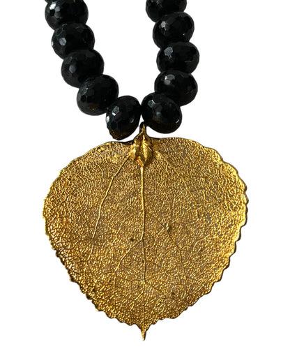 HEAVY BLACK FACETED BEAD NECKLACE w/ GILDED LEAF PENDANT